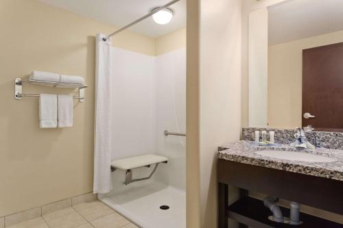 a bathroom with a sink and a shower at Super 8 by Wyndham Saskatoon Near Downtown in Saskatoon