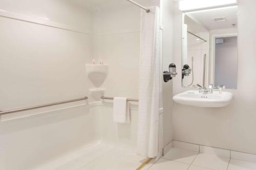 A bathroom at Microtel Inn & Suites Sault Ste. Marie