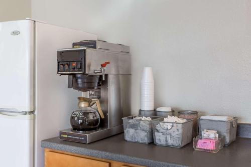 a kitchen counter with a coffee maker on a counter top at Knights Inn - Fredericksburg in Fredericksburg