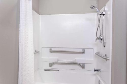 a white bathroom with a tub and a shower at Super 8 by Wyndham Rainsville in Rainsville