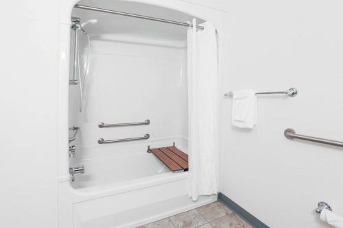 a bathroom with a shower and a tub at Super 8 by Wyndham Sault Ste. Marie in Sault Ste. Marie
