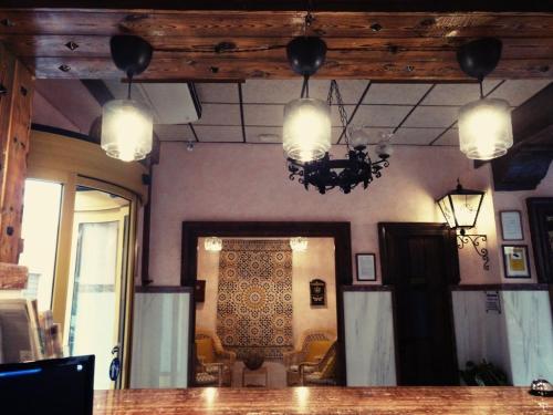 a dining room with a table and a chandelier at Balneario San Nicolas in Alhama de Almería