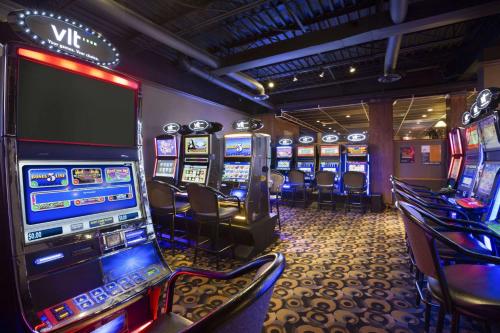 a casino with a bunch of slot machines at Central Suite Hotel in Lloydminster