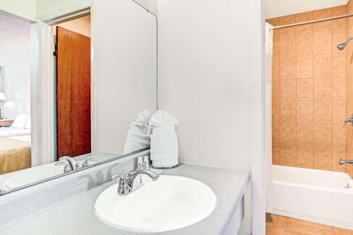 a bathroom with a sink and a mirror at Knights Inn Kissimmee in Kissimmee