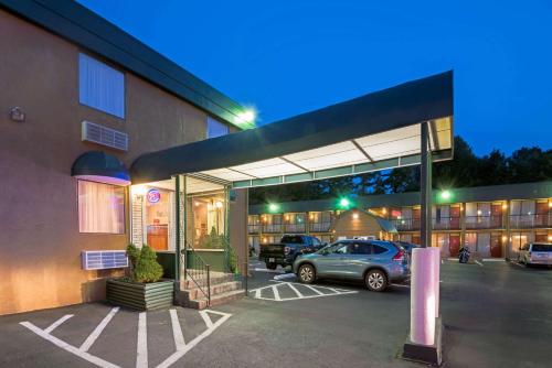 a car parked in a parking lot in front of a building at Travelodge by Wyndham Beckley in Beckley