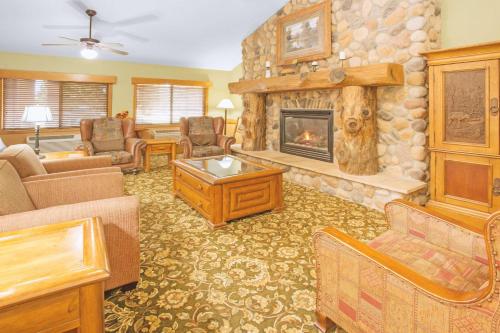 a large living room with a stone fireplace at Super 8 by Wyndham Davenport in Davenport