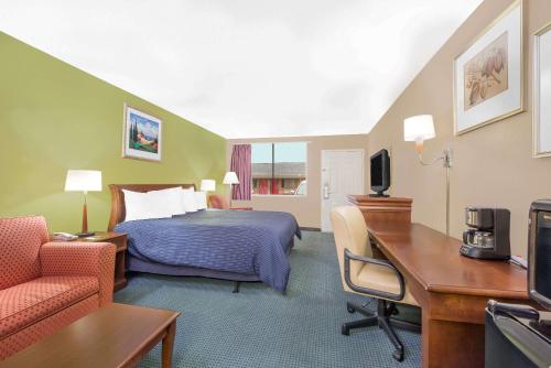 a hotel room with a bed and a desk at Hotel Express Anniston/Oxford in Anniston