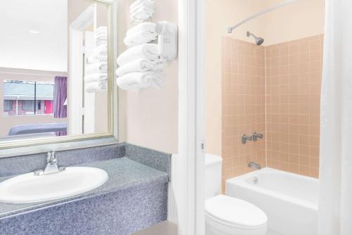 アニストンにあるHotel Express Anniston/Oxfordの洗面台、トイレ、鏡のあるバスルーム