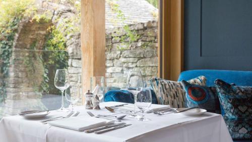 a table with a white table cloth and glasses at Priory Wareham in Wareham