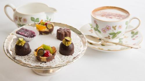 a plate of chocolate desserts and a cup of coffee at Priory Wareham in Wareham