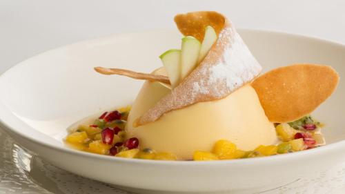 a white bowl of food with fruit and nuts at Priory Wareham in Wareham
