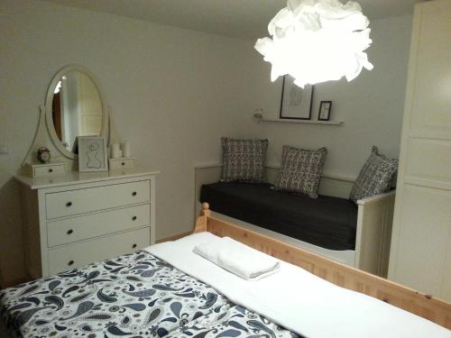 a bedroom with a bed and a mirror at Ferienwohnung Wiesmühlstrasse in Henndorf am Wallersee