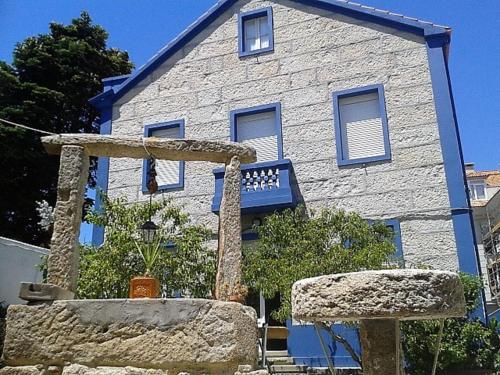 a building with a stone structure in front of it at Casa Guillan Illa de Arousa in Isla de Arosa