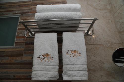 a group of towels on a towel rack in a bathroom at Sol Plaza Hotel in Puno
