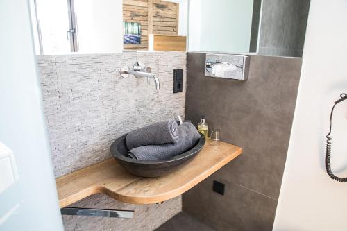 a bathroom with a bowl sink and a wooden counter at Hotel Weilerhof in Dormagen