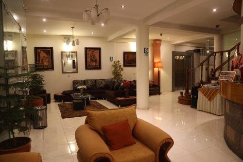 a living room with a couch and a living room at Sol Plaza Hotel in Puno