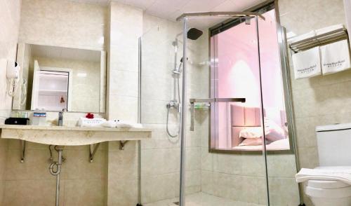 a bathroom with a shower and a sink at Ocean Star Hotel in Koror