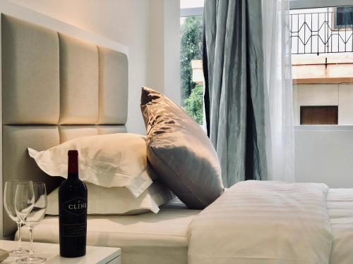 a bottle of wine sitting on a bed next to a window at Ocean Star Hotel in Koror