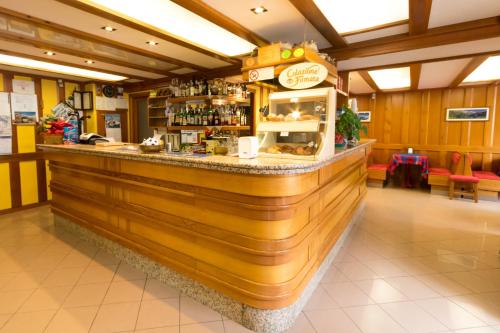 a wooden bar in a restaurant with a counter at Hotel Punta Cian in Valtournenche