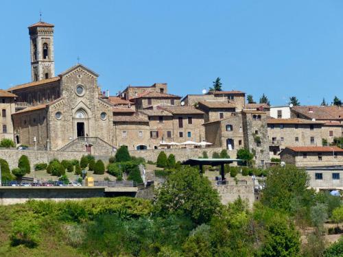 a group of buildings with a church in the background at Due Piani in Barberino di Val dʼElsa