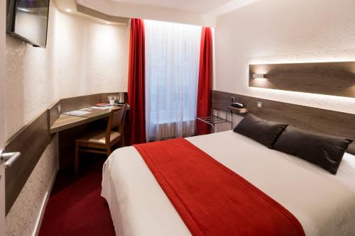 a hotel room with a bed and a desk at La Résidence in Lyon