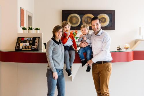 a family standing in front of a counter in a store at Hotel Prado in Ostend