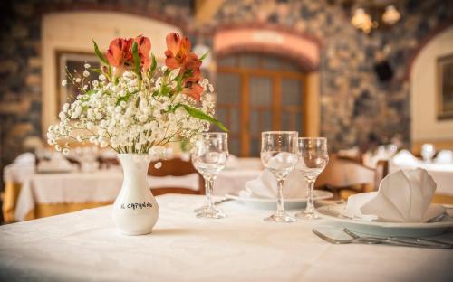a table with a white vase with flowers on it at Il Capanno in Pietra Ligure