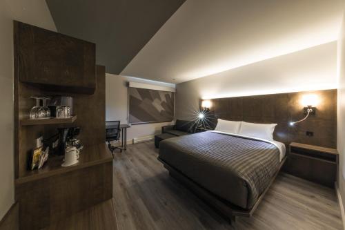 a hotel room with a bed and a couch at Hôtel & Suites Normandin Lévis in Lévis