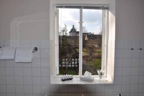 a bathroom with a window with a view of a building at Hotel Zollhaus in Schleswig
