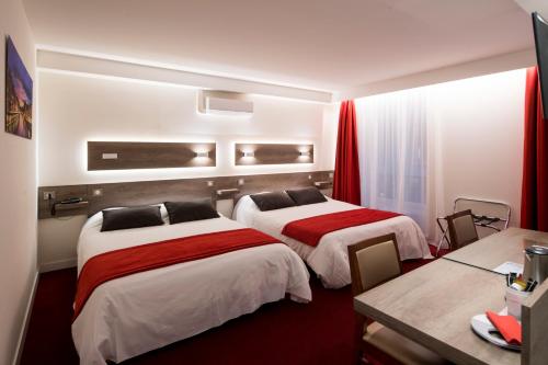 two beds in a hotel room with red curtains at La Résidence in Lyon