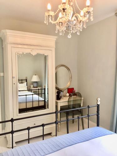 a bedroom with a mirror and a bed at Maison Hirondelles Hôtes in Mézières-sur-Issoire