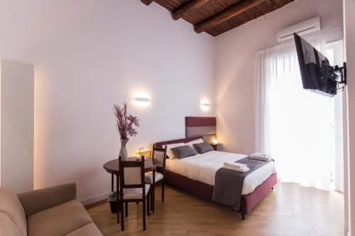 ナポリにあるSavoy Rivieraのベッドルーム1室(ベッド1台、テーブル、ソファ付)