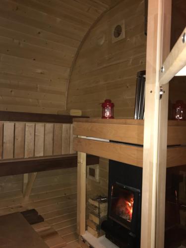 a fireplace in a log cabin with a fire at Chata Eden in Hrabušice