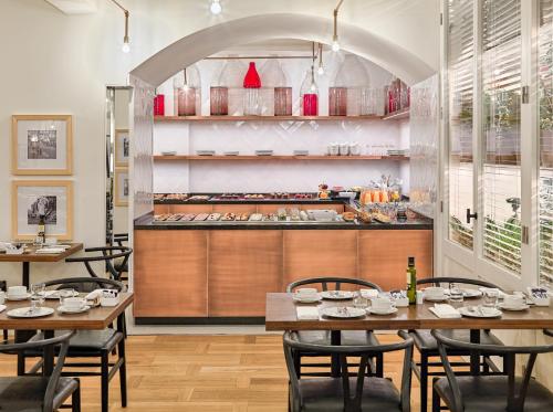 a restaurant with wooden tables and chairs and a counter at H10 Cubik 4* Sup in Barcelona
