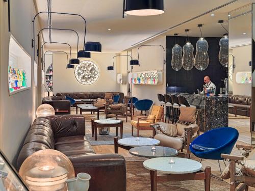 a store with leather couches and tables and chairs at H10 Cubik 4* Sup in Barcelona