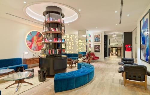 a large living room with blue couches and a table at H10 Cubik 4* Sup in Barcelona