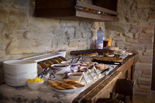 a buffet with plates of food on a table at Valbuona b&b in Mercatello sul Metauro