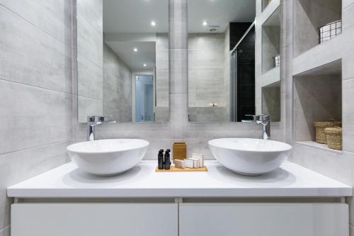 two sinks on a counter in a bathroom at Acropolis Core Bright & Modern Apartment by UPSTREET in Athens