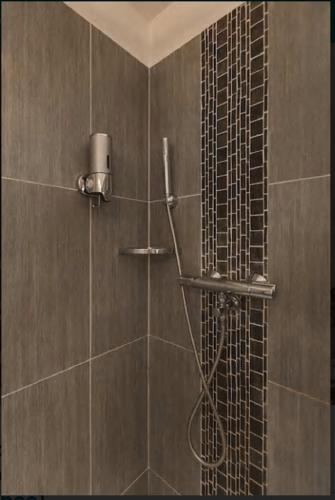 une douche dans une salle de bain avec un mur carrelé dans l'établissement Nice Renting - COLONNA - Best place in Nice Old Town, à Nice