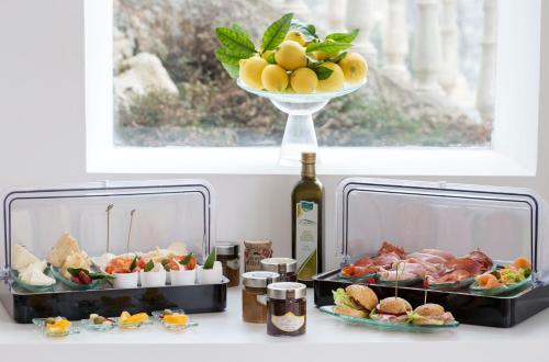 a table with two plates of food and a bottle of wine at Villa Paola in Tropea