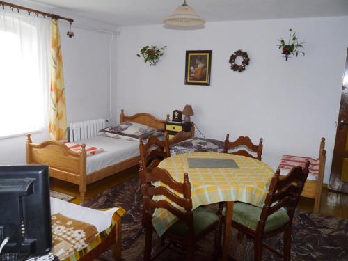 a bedroom with a table and chairs and a bed at Pod kasztanem gospodarstwo agroturystyczne in Stronie Śląskie