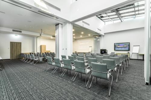 a conference room with chairs and a projection screen at Admiral Hotel in Zagreb