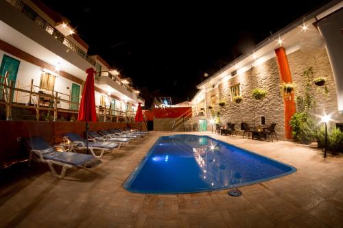 a swimming pool in the middle of a building at night at Hotel Villa Jazmin in Ica