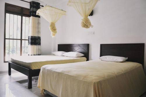 Postel nebo postele na pokoji v ubytování Medawatta Villa