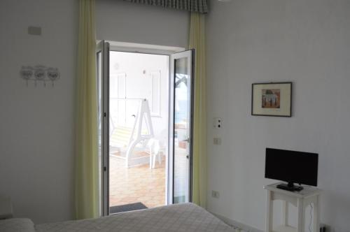 a bedroom with a bed and a door to a patio at La Citarea in Ischia