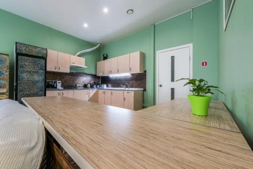 a kitchen with wooden cabinets and a wood floor at Hostel Mayakovsky in Moscow