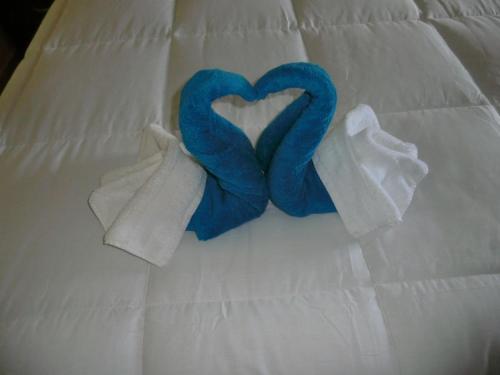 a pair of towels and two hearts on a bed at PG Quality Inn in Georgetown