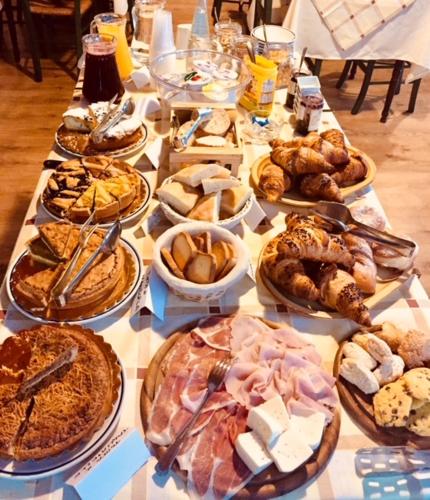 a table with many different types of pastries on it at R&B Casa Benassi in Riolunato