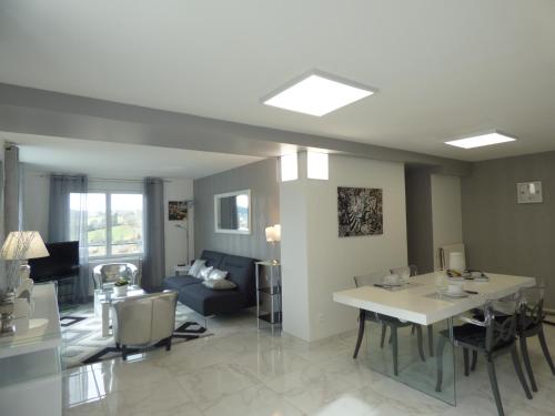 a living room with a table and a couch at Suite panoramique à Tulle in Tulle