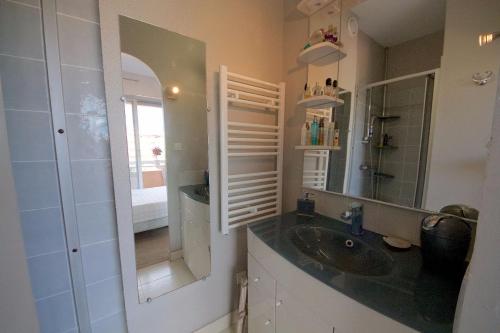 a bathroom with a sink and a mirror at Maxime plage in Sainte-Maxime